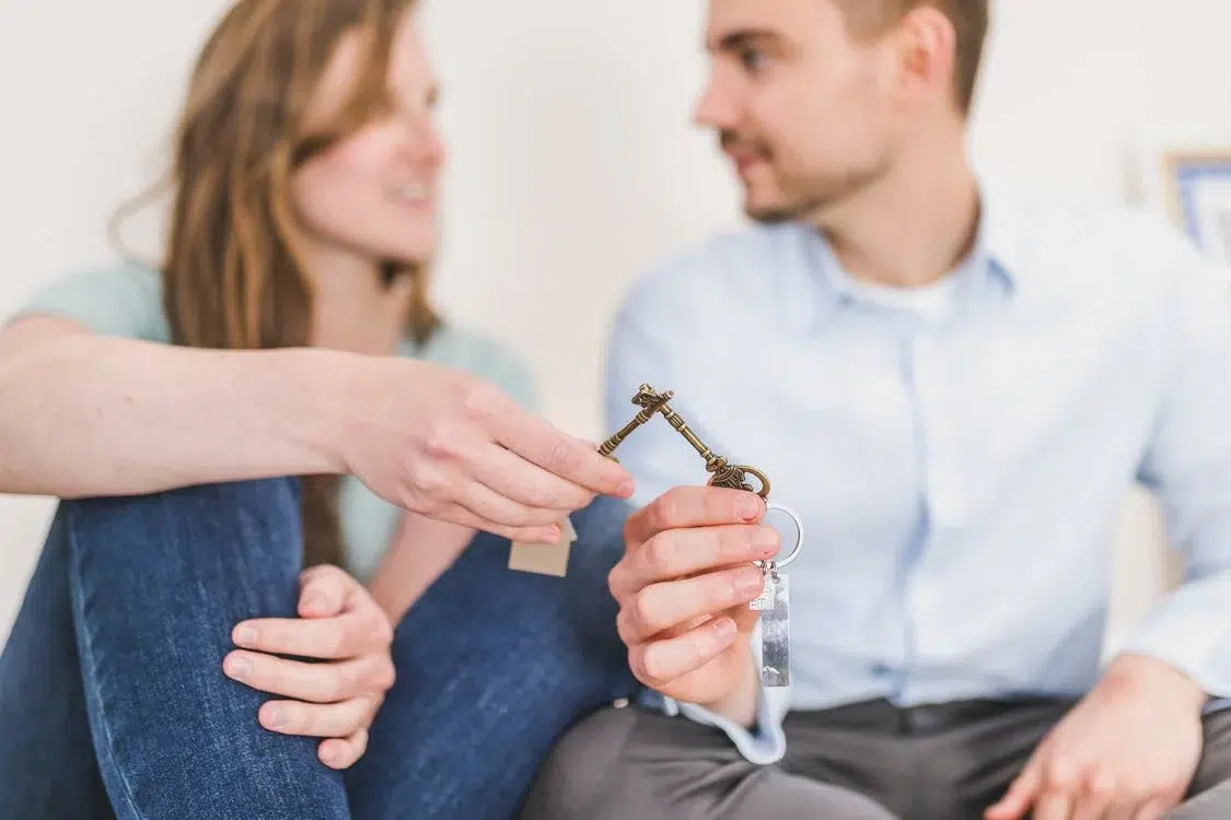 Man and woman holding dual keys