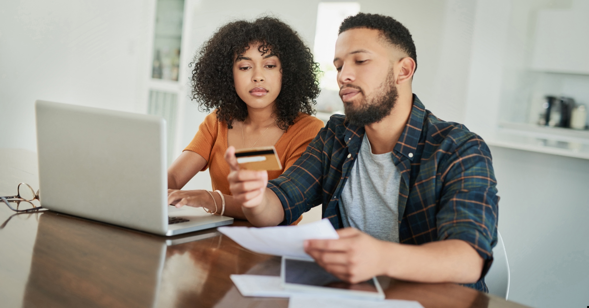 Leveraging Debt - couples looking at a display and card 