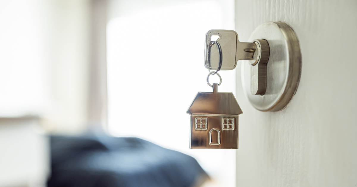 A visual representation of australian rental market by a key with having a dummy house as its keyring 