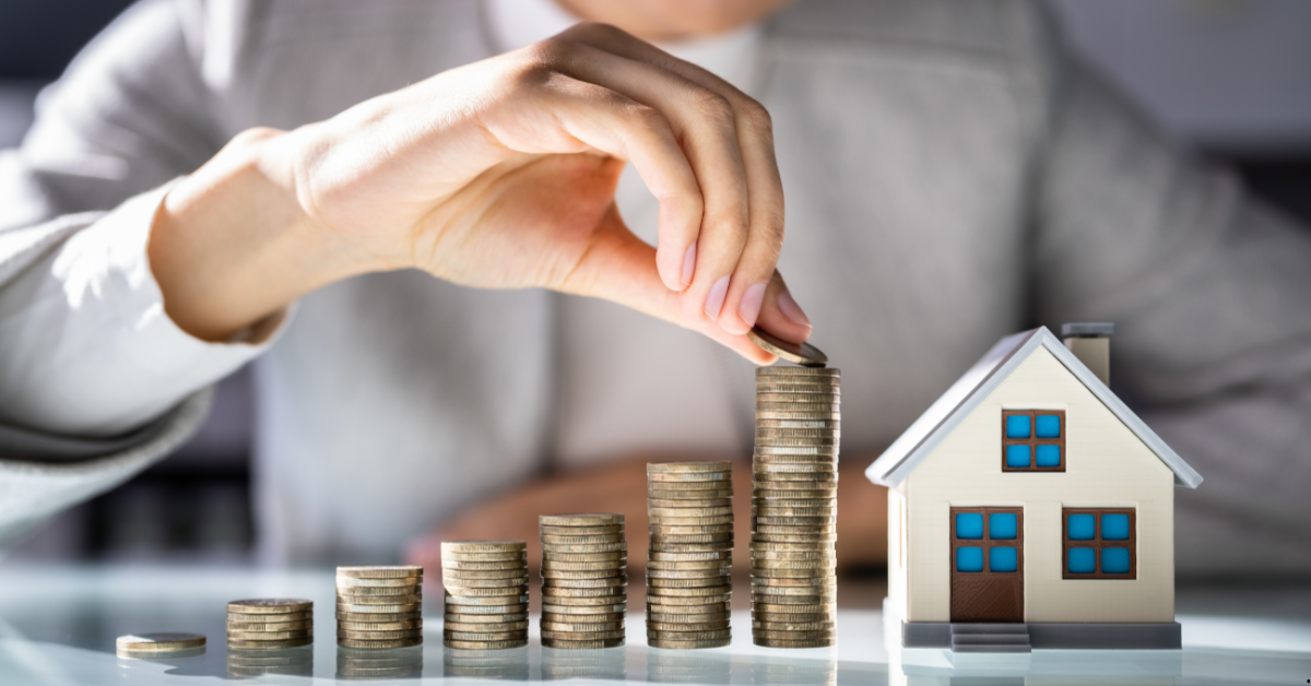 Australian property investor in 2024 showing investments in property market by coins and a dummy house on table
