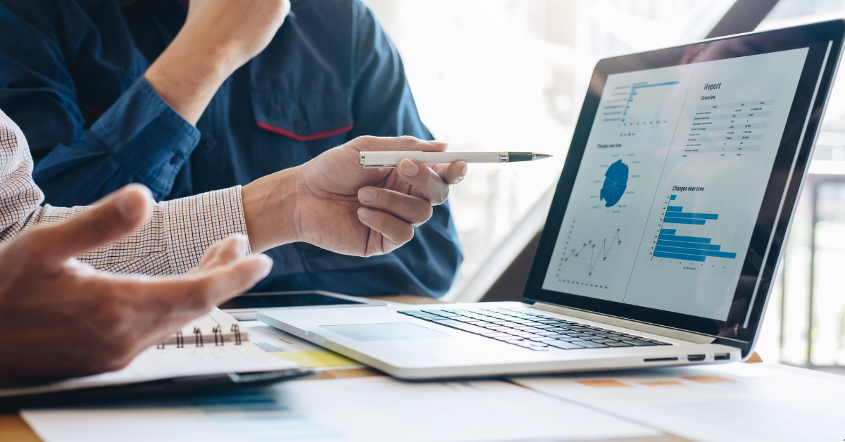 A person showing finance strategy with some graphs and data on a computer screen