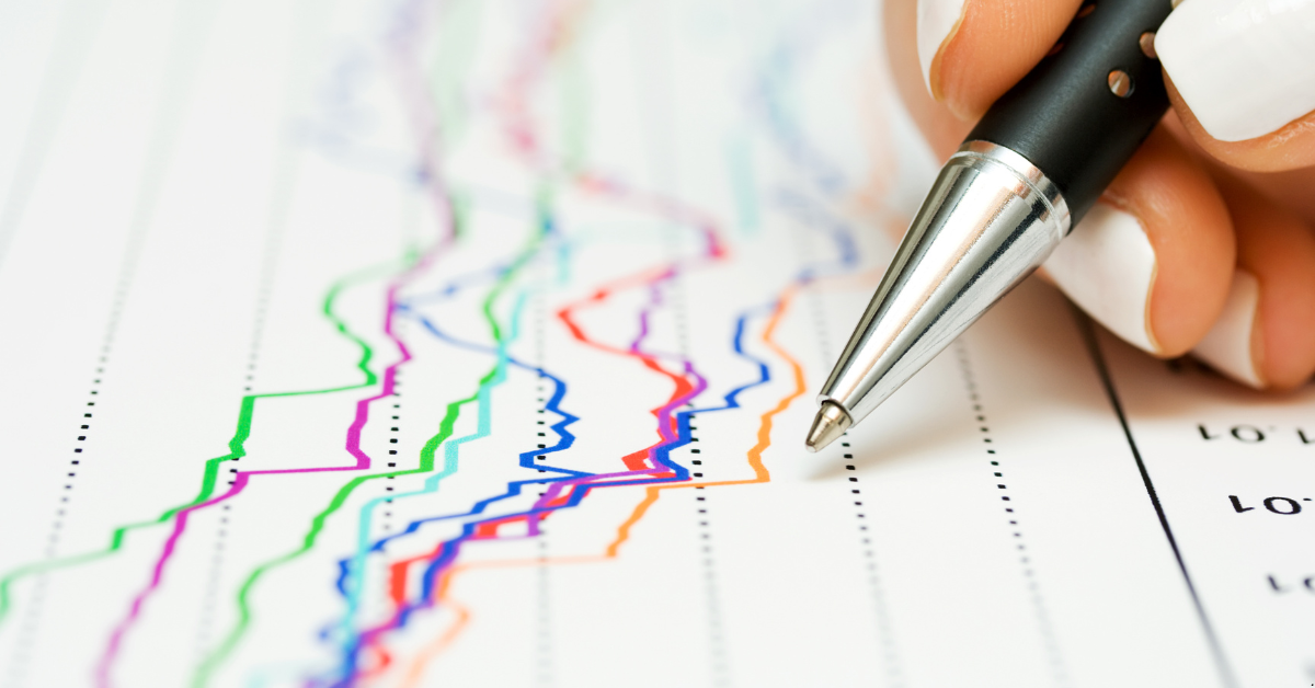 A person showing property market dynamics through different colored graphs and a pen