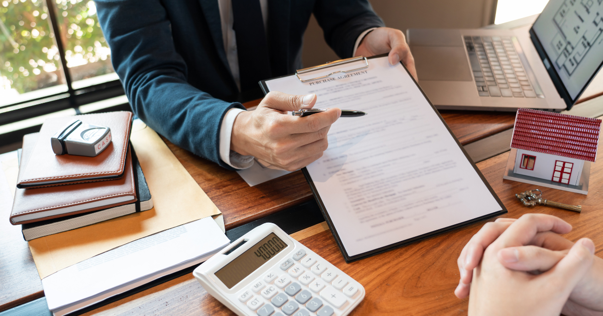 a professional is showing loan agreement to the investment property buyer