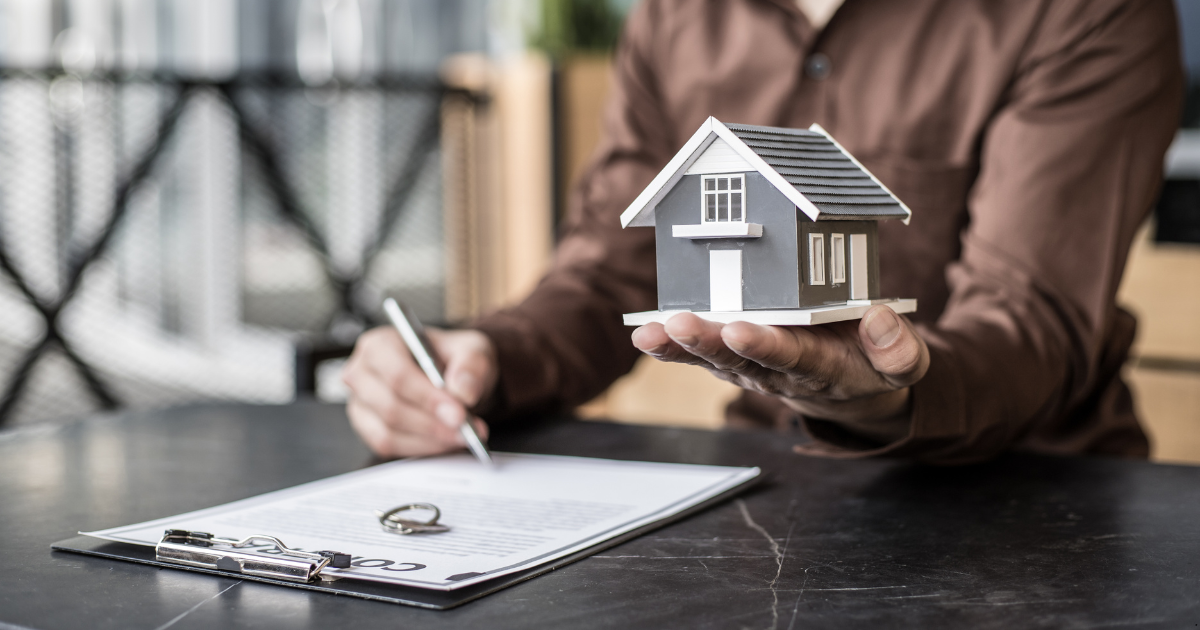 A professional is handing over a property to a property buyer